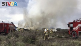 Rescue workers and firefighters are seen at the site where an Aeromexico airliner has suffered an 