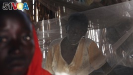FILE - A Sudanese woman suffering from malaria sits inside her makeshift house in Golo, Fashoda county in Upper Nile State May 29, 2014.