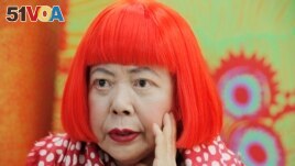 In this photo taken Wednesday, Aug. 1, 2012, Japanese avant-garde artist Yayoi Kusama, wearing a bright red wig and a Louis Vuitton polka dot scarf, speaks during an interview at her studio in Tokyo.