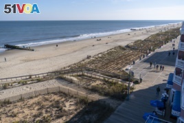 The beach and boardwalk are seen, Friday, Nov. 13, 2020, in Rehoboth Beach, Del. President-elect Joe Biden owns a $2.7 million, Delaware North Shores home with a swimming pool that overlooks Cape Henlopen State Park. (AP Photo/Alex Brandon)