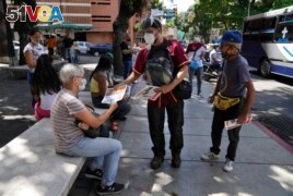 Juan Pablo Lares distributes free copies of a newspaper 