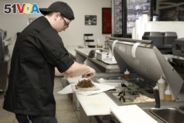 Chef Joseph Gattuso prepares a gyro sandwich. He's working in the kitchen of Frato's Pizza, but filling an online order for the virtual restaurant Halal Kitchen, in Schaumburg, Ill, on Sept. 6, 2019.