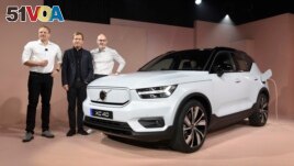 Henrik Green, left, Chief Technology Officer of Volvo said the company would stop selling vehicles powered by traditional engines by 2030. (AP Photo/Michael Owen Baker)
