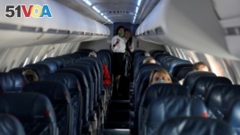 FILE - Passengers fly in a nearly empty cabin amid concerns of the coronavirus disease (COVID-19), during a Delta Airlines flight departing from Salt Lake City, Utah, U.S. April 11, 2020. (REUTERS/Jim Urquhart/File Photo)