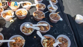 A few of the unusual foods available at the West Virginia Roadkill Cook-off. (Phil Dierking/VOA)