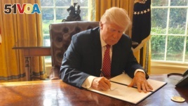 White House Press Secretary Sean Spicer tweeted this photo of President Donald Trump signing a new executive order to ban travelers from six Muslim-majority nations on Mar. 6, 2017. The media was not invited to see the president signing the order.