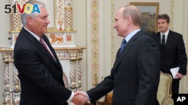 Vladimir Putin, at the time Russian Prime Minister, meets with Rex W. Tillerson, chairman and chief executive officer of Exxon Mobil Corporation.