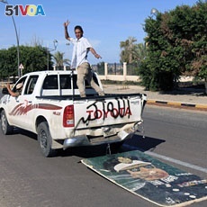 Anti-Gadhafi fighters in a vehicle after the fall of Sirte, October, 2011