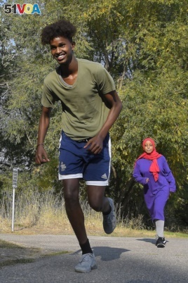 Mowlid Nur, left, and Ubah Yusuf go for a run during an Athletics United event in Logan, Utah