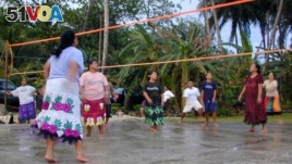 FILE - Women play volleyball April 9, 2004, in Kosrae, Micronesia. (AP Photo/Charles Hanley)