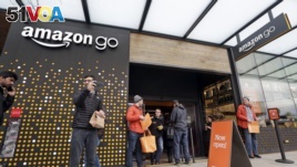 People stand outside an Amazon Go store Monday, Jan. 22, 2018, in Seattle. (AP Photo/Elaine Thompson)