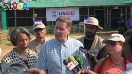 USAID Administrator Mark Green, center, speaks to reporters at the Balukhali Rohingya refugee camp in Cox's Bazar, Bangladesh, May 15, 2018.