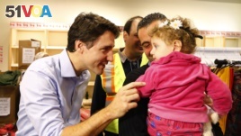 Syrian refugees are greeted by Canada's Prime Minister Justin Trudeau in 2015.