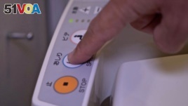 A person presses a button on the control panel of a Japanese toilet, in Tokyo, Japan September 22, 2019. (REUTERS/Lucien Libert)