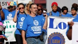 United Auto Workers union members march in the Labor Day Parade in Detroit, Michigan, Sept. 2, 2019.
