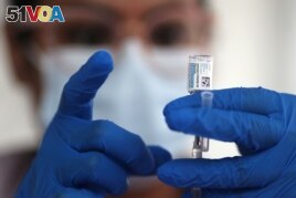 FILE - A nurse draws from a vial of Johnson & Johnson coronavirus vaccine, in Los Angeles, California, March 25, 2021.