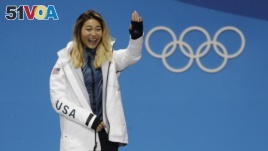 Women's halfpipe gold medalist Chloe Kim, of the United States, waves during the medals ceremony at the 2018 Winter Olympics in Pyeongchang, South Korea, Tuesday, Feb. 13, 2018. (AP Photo/Morry Gash)