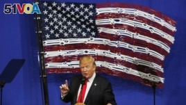 President Donald Trump speaks in front of an American flag made out of Snap-On Tools, Tuesday, April 18, 2017, in Kenosha, Wis. (AP Photo/Kiichiro Sato)