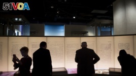 Visitors look at an exhibit about the Dead Sea Scrolls during a media preview of the Museum of the Bible in Washington, D.C., Nov. 14, 2017. 