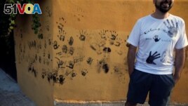 FILE - These handprints are from black paint for Spain's Black Paint Festival September 6, 2019. ( REUTERS/Jon Nazca)