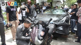 In this Sept. 3, 2012, photo, a Ferrari, that was driven by Vorayuth Yoovidhya, a grandson of late Red Bull founder Chaleo Yoovidhya, and a motorcycle, both involved in an accident, are displayed by police in Bangkok, Thailand.