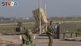 An Israeli soldier guards an Iron Dome air defense system deployed in the Israeli controlled Golan Heights near the border with Syria. (File)