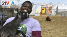 This April 10, 2020 photo shows Marshall Mitchell, Urban Farm Assistant at the Urban Growers Collective farm in Chicago. The nonprofit teaches young kids and others to grow vegetables at eight urban farms around the city. (Laurell Sims via AP)