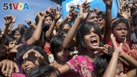 FILE - Rohingya refugee children shout slogans during a protest against repatriation on Nov. 15, 2018. In Myanmar, misinformation, like hate speech and propaganda, fueled violence against Rohingya Muslims. (AP Photo/Dar Yasin)