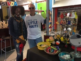 Vendor Aura Bond and author, tour guide David C. Brown in front of Aura's stand at the Caribbean Marketplace in Little Haiti, Miami, Florida. (Photo: S. Lemaire /VOA)