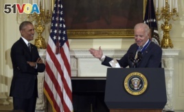 Vice President Joe Biden, right, speaks as President Barack Obama, left, listens, during a ceremony in the State Dining Room of the White House in Washington, Thursday, Jan. 12, 2017.