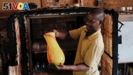 Ghana's only glassblower Michael Tetteh produces glassware at his glassware manufacturing workshop, in Krobo Odumase.
Picture taken March 18, 2022. (REUTERS/Francis Kokoroko)