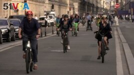 People ride on Rivoli street in Paris, Wednesday, Sept. 13, 2023. (AP Photo/John Leicester)