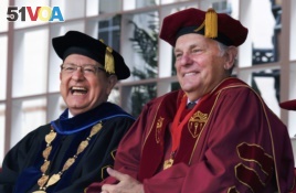 President of the University of Southern California C.L. Max Nikias, left, laughs with head of USC Board of Trsstees John Mork, during USC's 134th graduation ceremony in Los Angeles on Friday, May 12, 2017.
