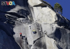 Kevin Jorgeson, left, and Tommy Caldwell climb El Capitan, Wednesday, Jan. 14, 2015, as seen from the valley floor in Yosemite National Park
