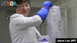 Researcher Ryu Young-joon holds a container that stores human tissue and other human biological samples at Kangwon National University Hospital in Cuncheon, South Korea. Ryu exposed breakthrough cloning research as a devastating fake.