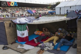 Central American migrants rest at the Jesus Martinez stadium in Mexico City, Tuesday, Nov. 6, 2018.