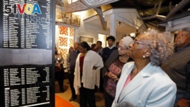 In this Nov. 10, 2017 image, Ellie Dahmer, foreground, wife of Vernon Dahmer of Hattiesburg, who was killed in 1966 by the Ku Klux Klan, their daughter Bettie Dahmer, and an older brother Harold, right at the Mississippi Civil Rights Museum.