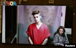 Getting arrested for driving drunk and drag racing on a main thoroughfare in a rented sports car is a bit of fiasco. Pop singer Justin Bieber might have a different word for it. Here, he appears via video conference in his first court appearance in Miami, Florida, January 2014. (REUTERS FILE PHOTO)