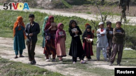 Afghan children hold the holy Koran as they go to a madrasa (religious school) in Dand Ghori district in Baghlan province, Afghanistan, March 15, 2016. 