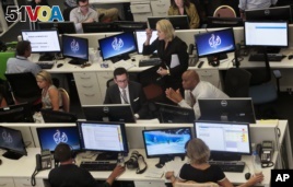 FILE - This Aug. 20, 2013 file photo shows Al-Jazeera America editorial newsroom staff preparing for their first broadcast in New York. (AP Photo/Bebeto Matthews)