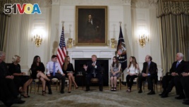 President Donald Trump hosts a listening session with high school students, teachers and parents in the State Dining Room of the White House in Washington, Wednesday, Feb. 21, 2018. (AP Photo/Carolyn Kaster)