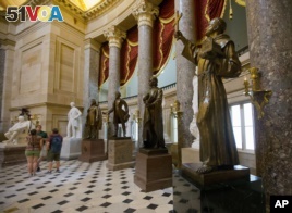A statue of missionary Junipero Serra, right, is seen in Statuary Hall, also known as the Old Hall of the House, on Capitol Hill in Washington, D.C., July 2, 2015.