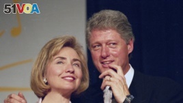 In this June 22, 1994 file photo, President Bill Clinton and first lady Hillary Clinton for supporters in Washington. (AP