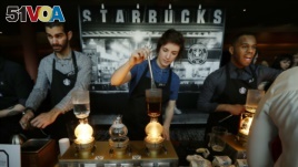 FILE - Starbucks employees prepare coffee in the lobby of the company's annual shareholders meeting in Seattle, Washington, March 23, 2016.