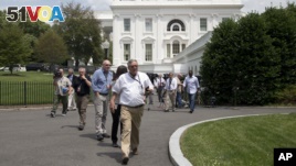 Reporters and others are evacuated from the White House, June 9, 2015, following a bomb threat.