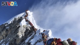 In this photograph from May 22, 2019, a long line of climbers move through the Everest 'death zone.' (Nimsdai Project Possible v<I>&#</i>237;a AP)