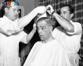 Actor Boris Karloff gets into make up on for his role as ...