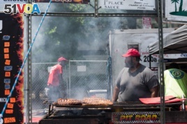 An employee of Smoke Shack waits for ribs to cook on Sunday, June 25, 2017 at the National Capital Barbecue Battle in Washington D.C.