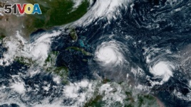 A satellite image from earlier this year shows several major storms and hurricanes in the Atlantic Ocean. Scientists say hgher temperatures could make such ocean storms worse.