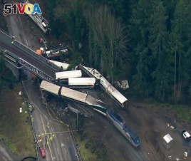 This aerial image from video provided by KOMO-TV, shows the site of an Amtrak train that derailed south of Seattle on Dec. 18, 2017.